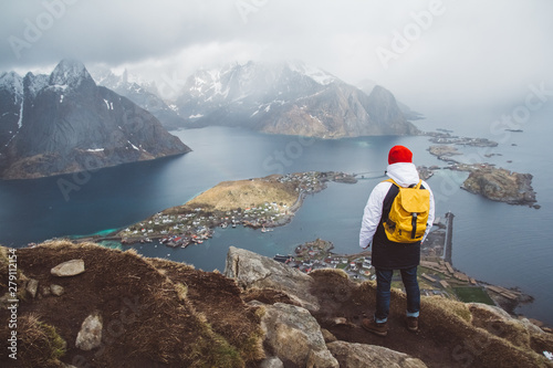 Man traveler hiking on Reinebringen mountain ridge in Norway lifestyle adventure traveling © Andriy