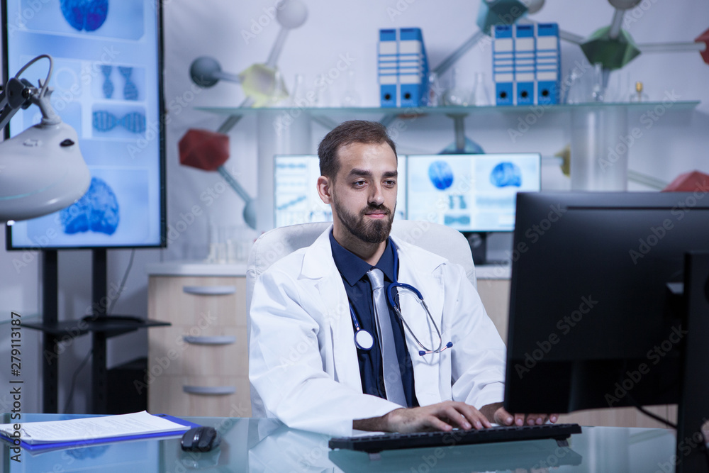 Portrait of young doctor in white coat working in his hospital office Portrait of young doctor in white coat working in his hospital office