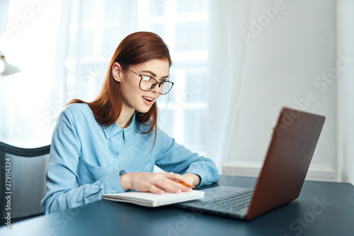 young woman working on laptop at home