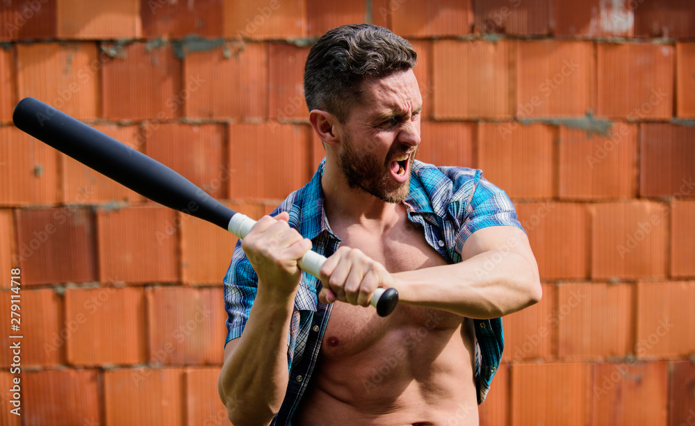 Feel my strength. Man unshaven face muscular torso hold black baseball bat. Strong temper. Confident his strength. Bully guy carry cudgel wall background. Power and strength. Attack concept Stock Photo