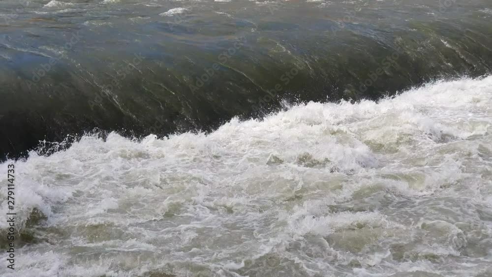 The flow of rapid mountain rivers. Chaotic movement of water bubbling after the waterfall.