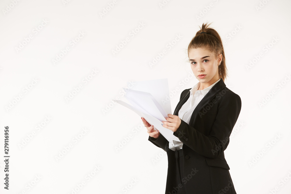 Girl in office clothes standing with white paper in his hands, shot on a clean white background. Girl in office clothes standing with white paper in his hands, shot on a clean white background.