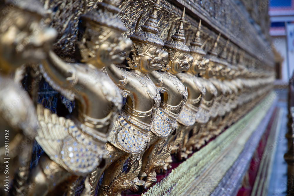 Fototapeta premium Close view of aligned statues from the Royal temple in Bangkok