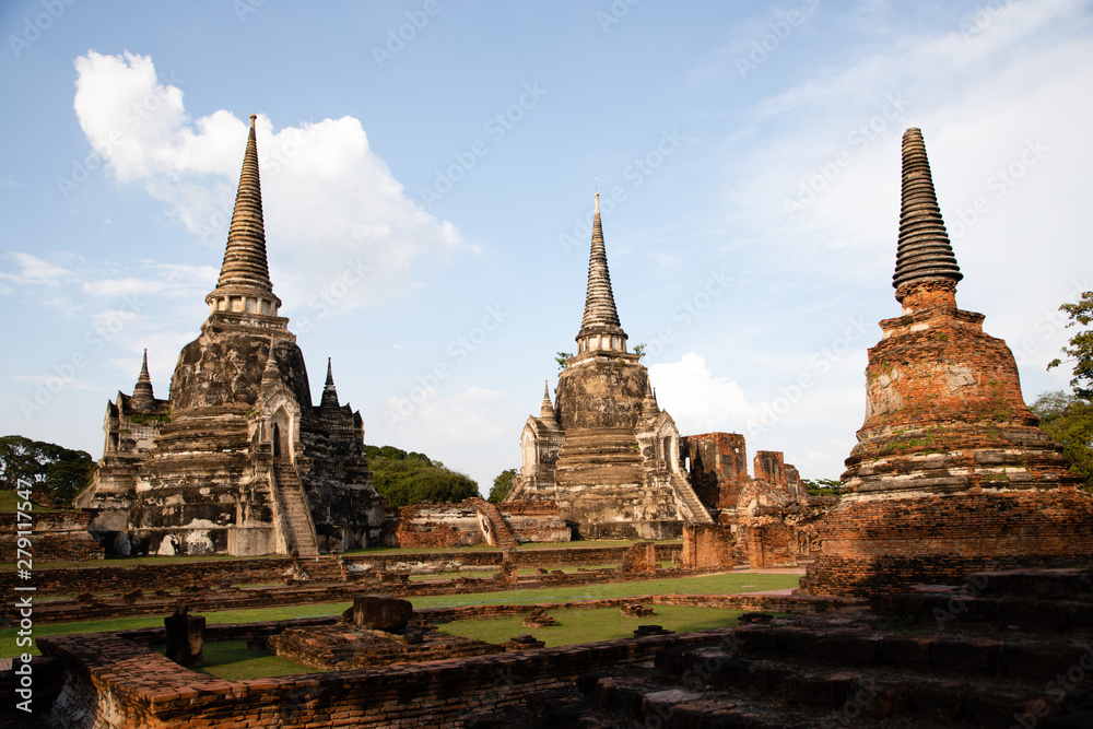 Distant view of the Ayutthaya ruined temple in Thailand with the blue sky as background