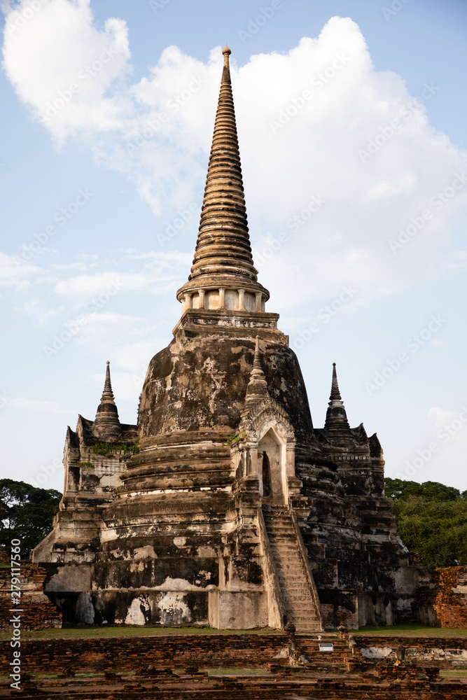 View of a single pagoda from the Ayutthaya ruined temple in Thailand with white sky as background