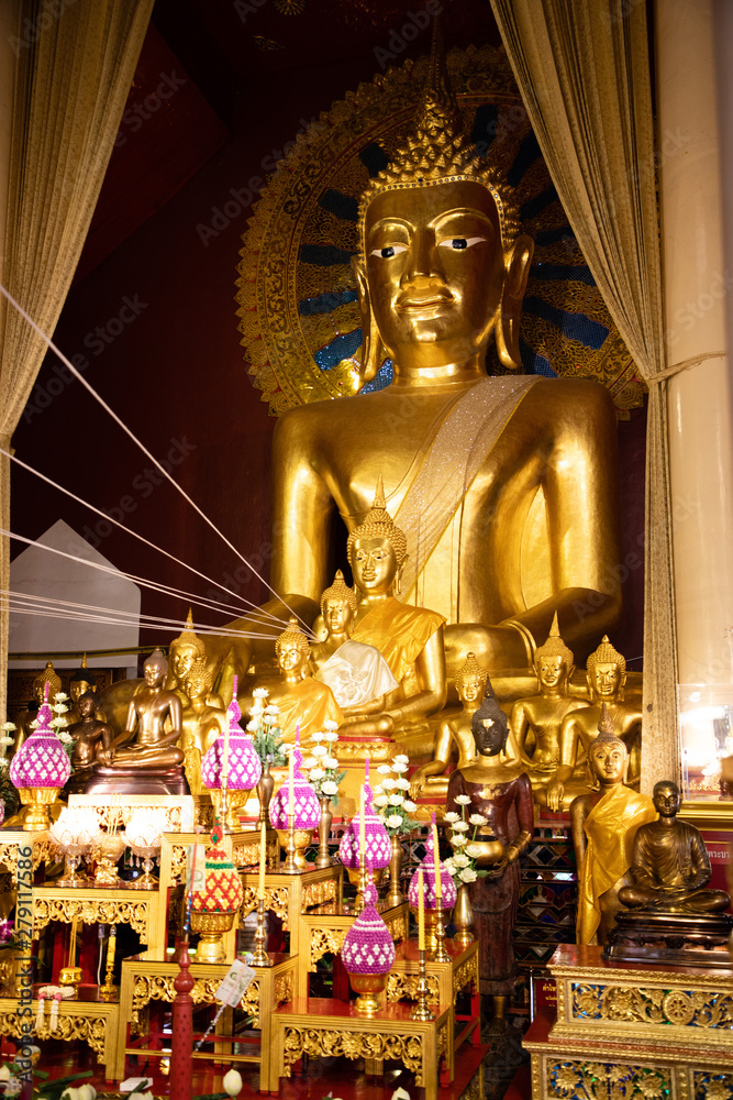 November 21th, 2018 - Ayutthaya (THAILAND) - Giant golden Buddha surrounded by smaller golden Buddhas in thai temple