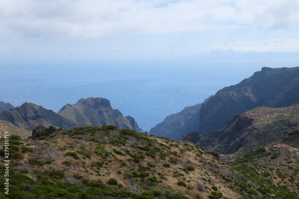 Naklejka premium Green mountain cliffs with sea on the background (Tenerife - SPAIN)
