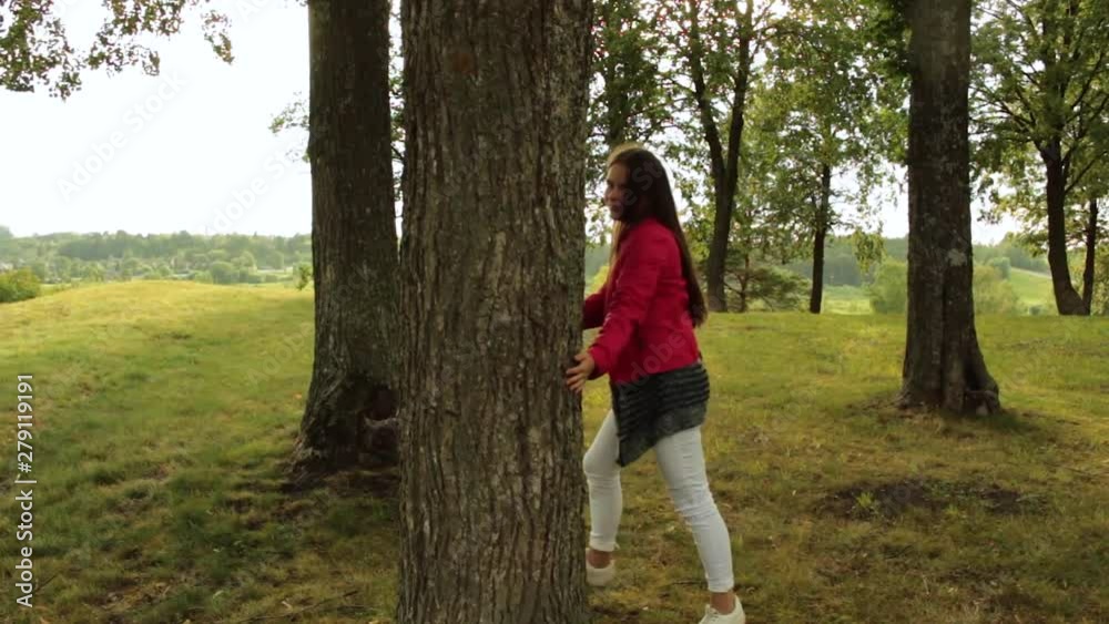 Girl hugging, walking around the tree Girl hugging, walking around the tree
