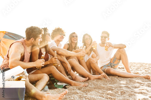 Group of cheerful happy friends camping at the beach © Drobot Dean