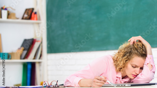 Tired tutor fall asleep at workplace. Tired student lean on desk. Exhausting lesson. Teacher exhausted after hard working day. Woman tired in school classroom. School pedagogue stressful occupation