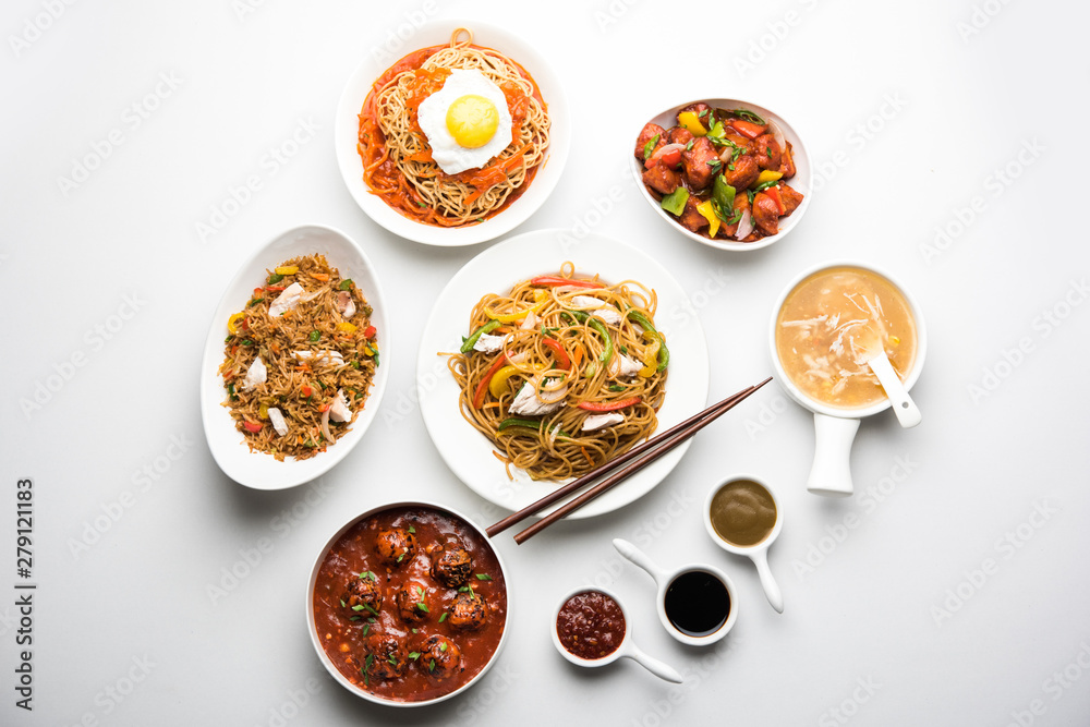 Assorted Indo chinese food in group includes non vegetarian or chicken Schezwan/Szechuan hakka noodles, fried rice, manchurian, egg american chop suey, soup with spoon and chop sticks, selective focus Assorted Indo chinese food in group includes non vegetarian or chicken Schezwan/Szechuan hakka noodles, fried rice, manchurian, egg american chop suey, soup with spoon and chop sticks, selective focus