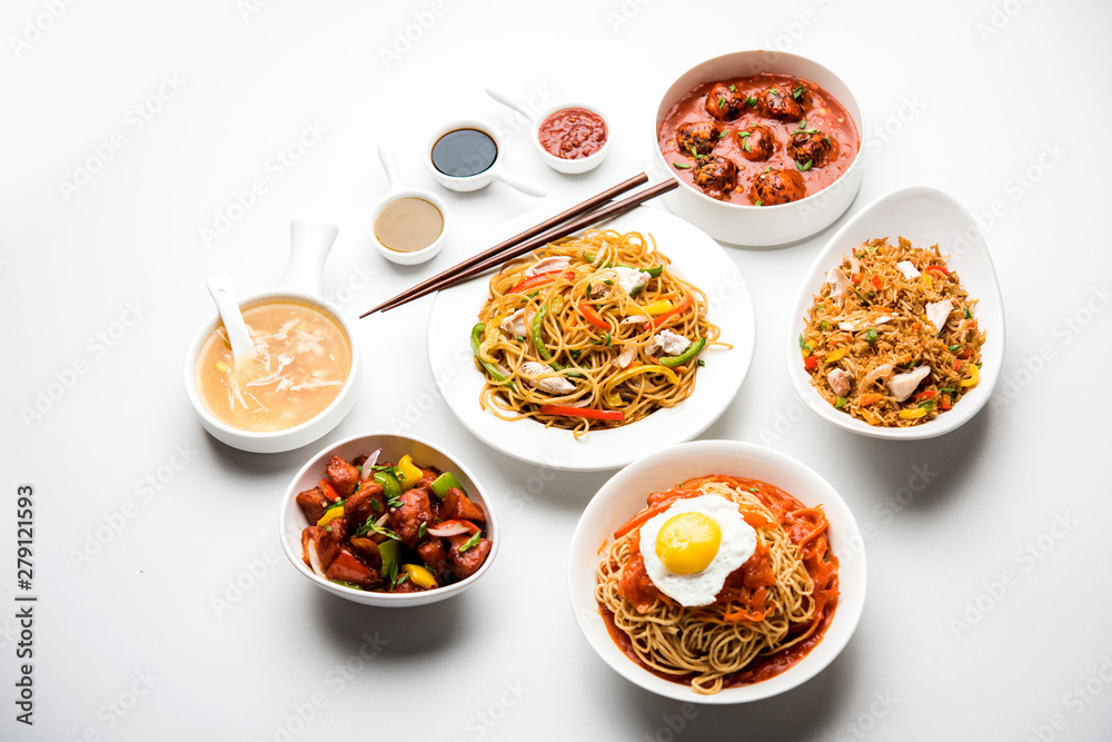 Assorted Indo chinese food in group includes non vegetarian or chicken Schezwan/Szechuan hakka noodles, fried rice, manchurian, egg american chop suey, soup with spoon and chop sticks, selective focus Assorted Indo chinese food in group includes non vegetarian or chicken Schezwan/Szechuan hakka noodles, fried rice, manchurian, egg american chop suey, soup with spoon and chop sticks, selective focus