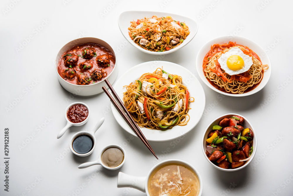 Assorted Indo chinese food in group includes non vegetarian or chicken Schezwan/Szechuan hakka noodles, fried rice, manchurian, egg american chop suey, soup with spoon and chop sticks, selective focus Assorted Indo chinese food in group includes non vegetarian or chicken Schezwan/Szechuan hakka noodles, fried rice, manchurian, egg american chop suey, soup with spoon and chop sticks, selective focus