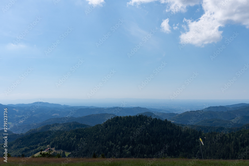 Panoramic view of the mountains under the blue cloudy sky in summer