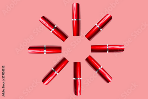 Red lipstick and nail polish on a pink background. Isolated pattern.