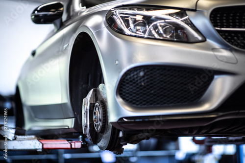 Car in a garage for maintenance, oil/tyre change (shallow DOF  color toned image) © lightpoet