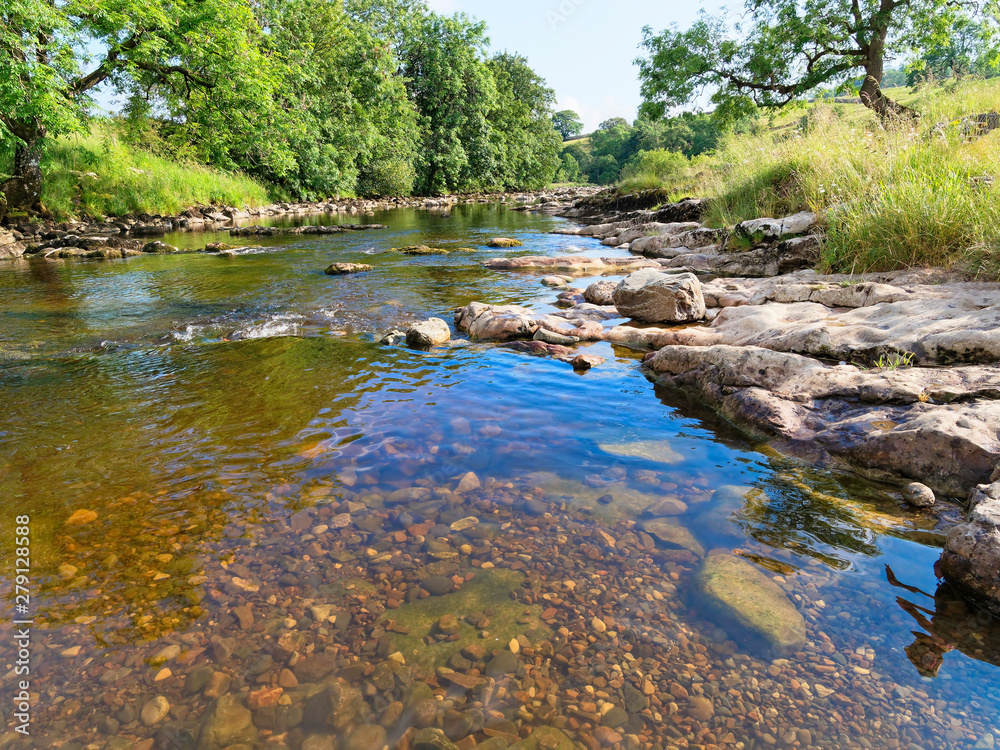 Crystal clear shallow waters of the River Ribble near Little Stainforth in Yorkshire. Crystal clear shallow waters of the River Ribble near Little Stainforth in Yorkshire.