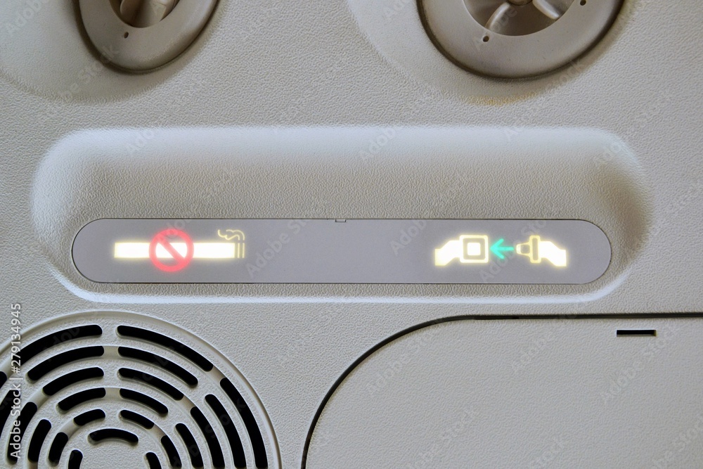 Fasten Seat belt sign and No Smoking sign in the airplane interior