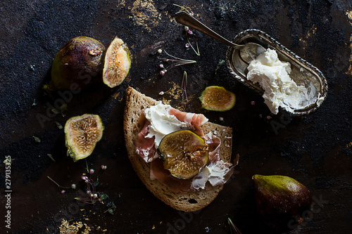 summer meal with rye bread, parma ham and figs