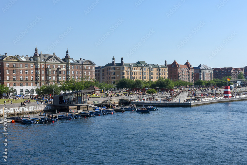 People sunbathing in the center of Copenhagen on Denmark