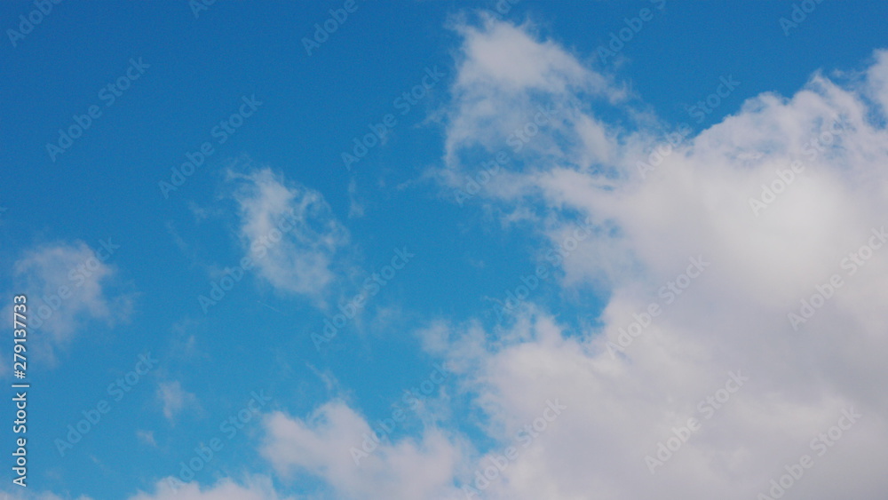 White clouds floating in the blue sky.