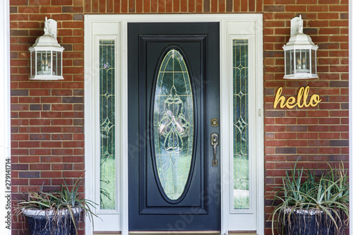 Black Front door of Traditional red brick home