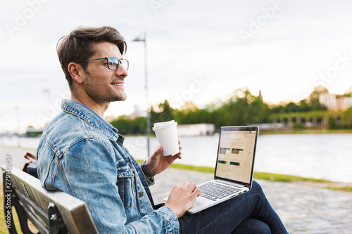 Handsome young man dressed casually spending time outdoors