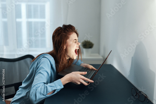 young woman working on her laptop at home