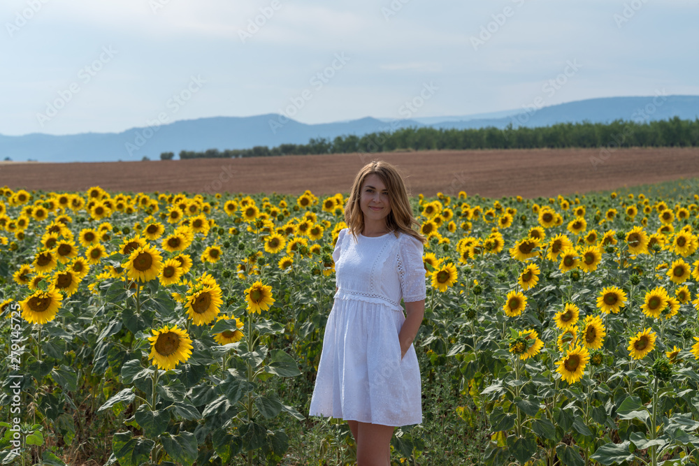 Woman in a sunflower field, Provence, France Woman in a sunflower field, Provence, France