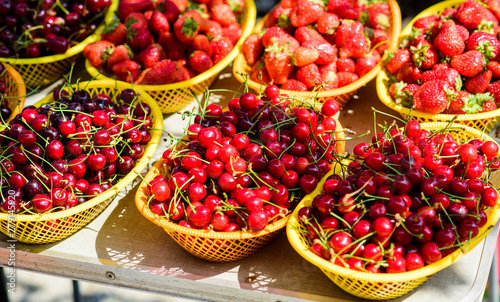 vitamin and dieting. seasonal fruit. natural shopping. organic useful food. healthy lifestyle. farm market. summer berry market. ripe cherries cherry. red strawberry in basket. Berry background