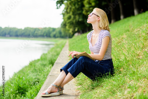 woman in park reading book. student girl with book outdoor. inspired by novel author. interesting story. Relax and get new information. reading is my hobby. Summer study. Book store concept photo