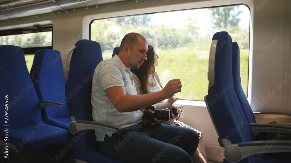 A couple in love traveling in the elektro train looking through the window at the surroundings. A couple in love traveling in the elektro train looking through the window at the surroundings.