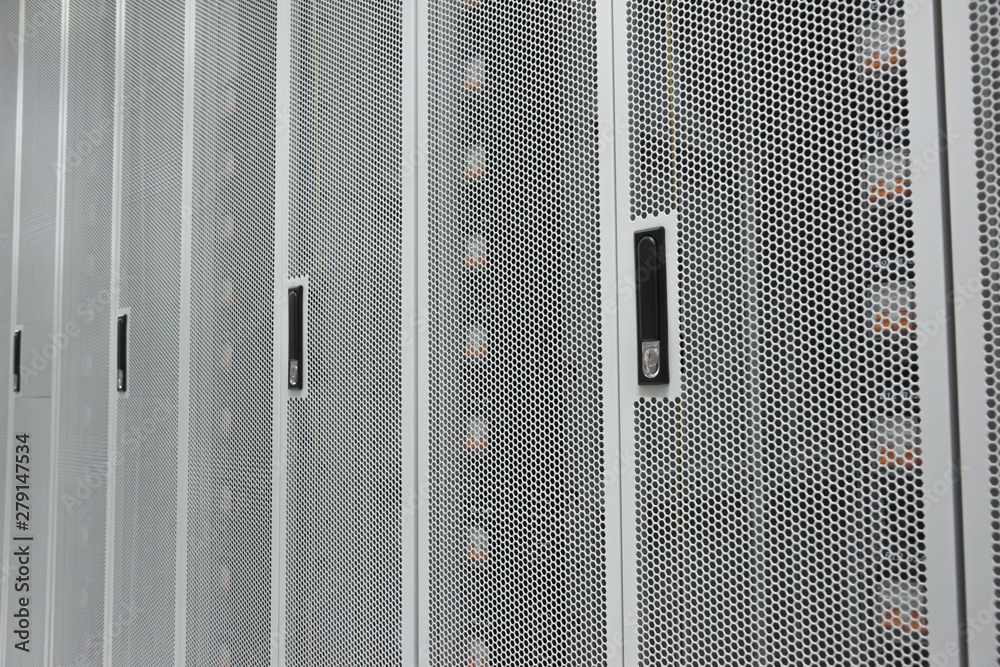 Data center white metal grid cabinet door side close-up Data center white metal grid cabinet door side close-up