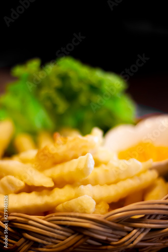 Tasty french fries and ketchup on wooden table background