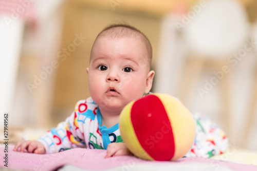 newborn baby boy playing on the floor