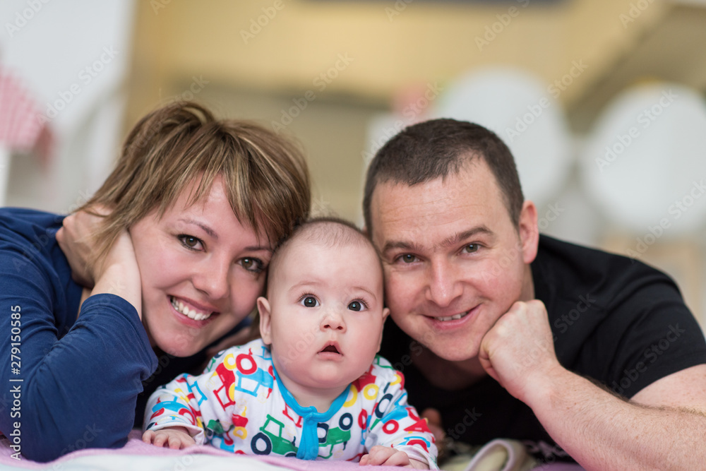 Portrait of young happy couple with their adorable baby boy Portrait of young happy couple with their adorable baby boy