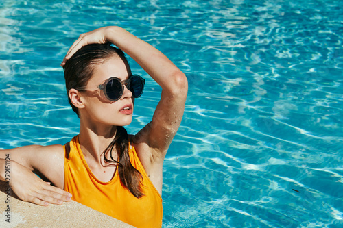young woman in black goggles in swimming pool