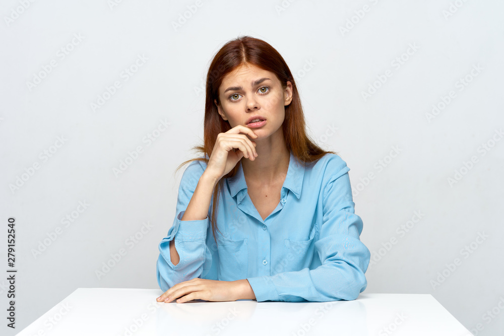portrait of a young woman sitting at desk portrait of a young woman sitting at desk