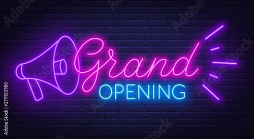 Grand opening neon sign on dark background.