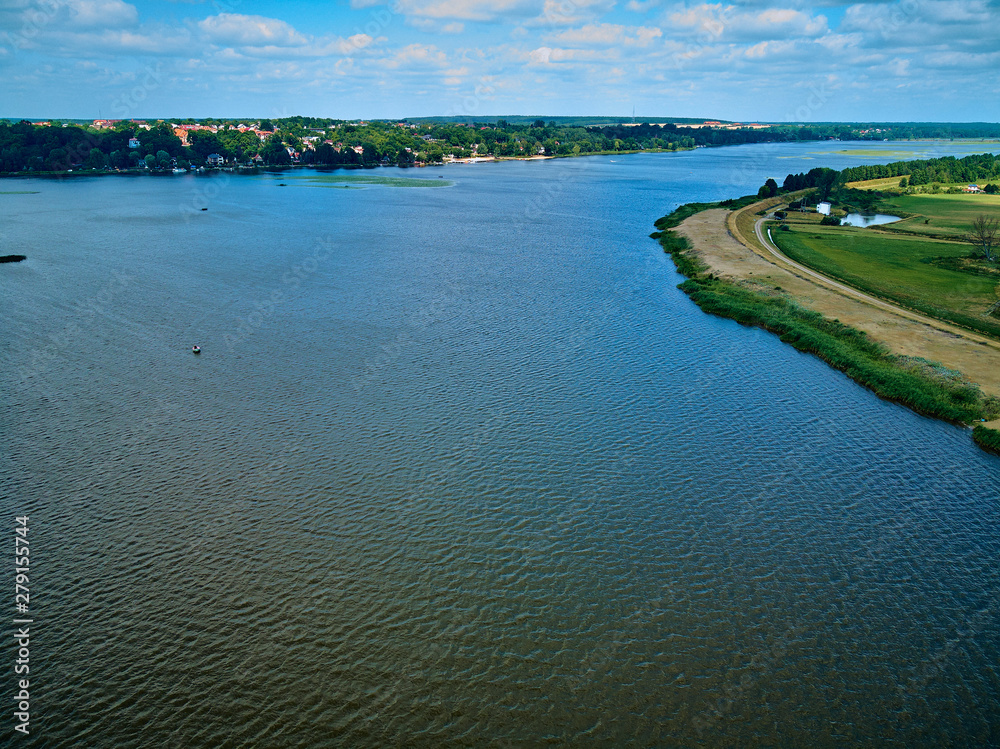 Beautiful panoramic aerial drone view to the place of connecting the Bug and Narew rivers with a warm summer day in July, Poland, Masovian Beautiful panoramic aerial drone view to the place of connecting the Bug and Narew rivers with a warm summer day in July, Poland, Masovian