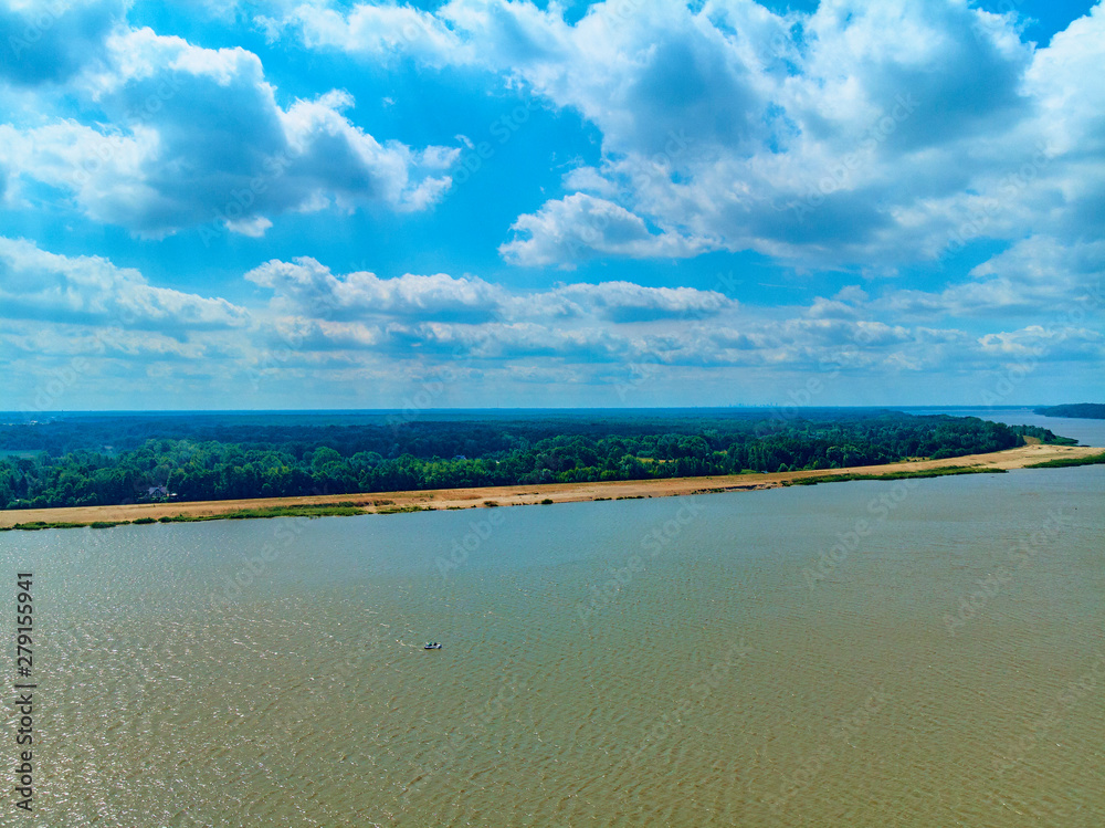 Beautiful panoramic aerial drone view to the place of connecting the Bug and Narew rivers with a warm summer day in July, Poland, Masovian