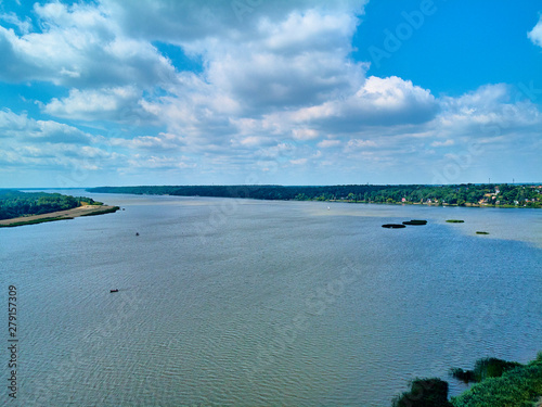 Beautiful panoramic aerial drone view to the place of connecting the Bug and Narew rivers with a warm summer day in July, Poland, Masovian