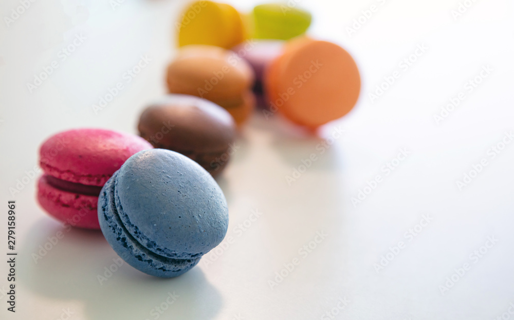 Colorful macarons on white background, close up view Colorful macarons on white background, close up view