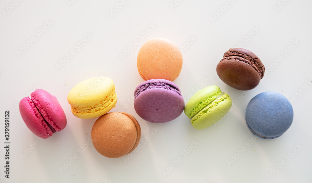 Colorful macarons on white background, close up view Colorful macarons on white background, close up view