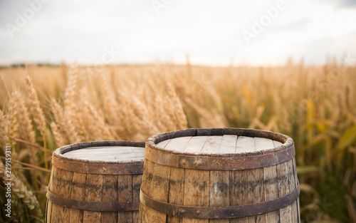 wood board table in front of field of wheat on sunset light. Ready for product display montage