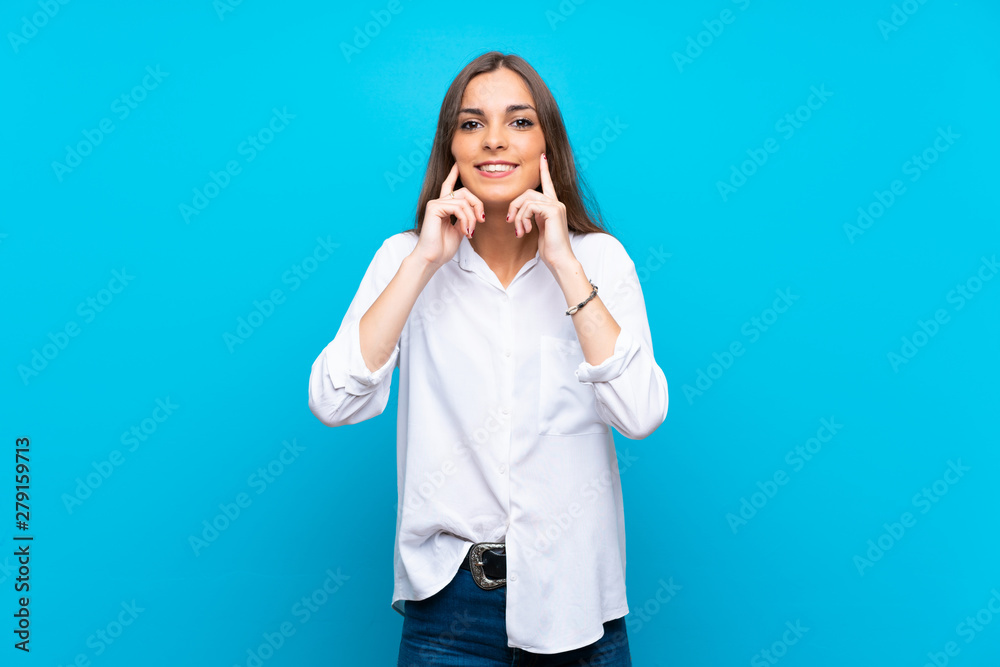 Young woman over isolated blue background smiling with a happy and pleasant expression Young woman over isolated blue background smiling with a happy and pleasant expression