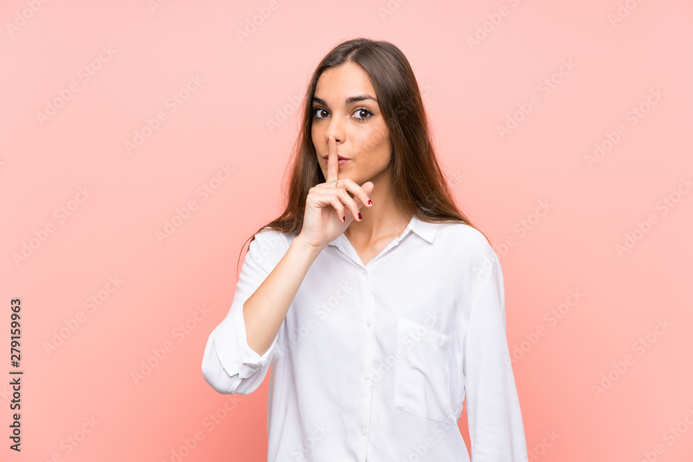 Young woman over isolated pink background doing silence gesture Young woman over isolated pink background doing silence gesture