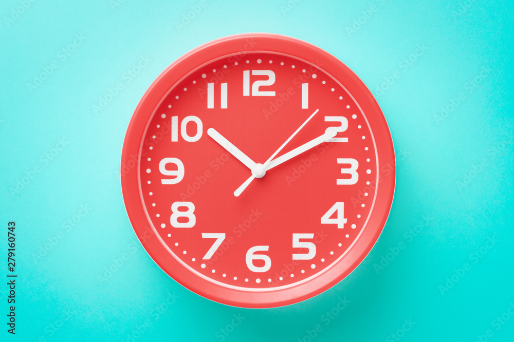 Top view closeup red alarm clock on green background Top view closeup red alarm clock on green background