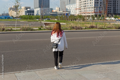 Full-length portrait  young beautiful girl walking down the street  summer outdoors