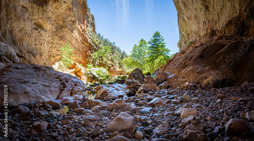 Bild auf Leinwand Inside Tonto Natural Bridge in the mountains of Arizona looking out from behind a waterfall